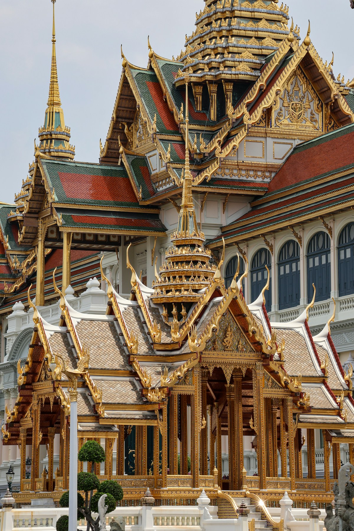 Ornate thai temple architecture with golden spires and roofs.
