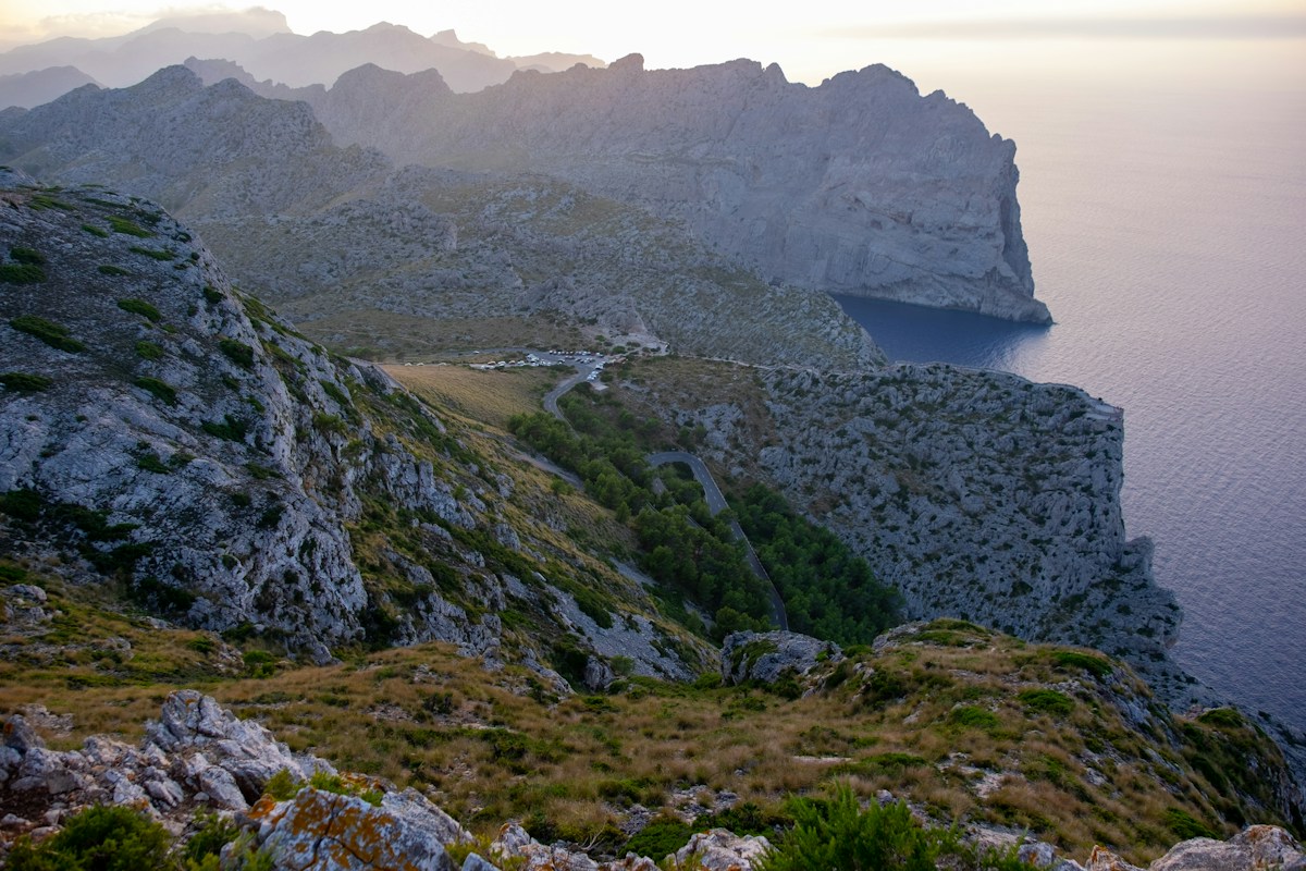 a view of a mountain with a body of water in the distance