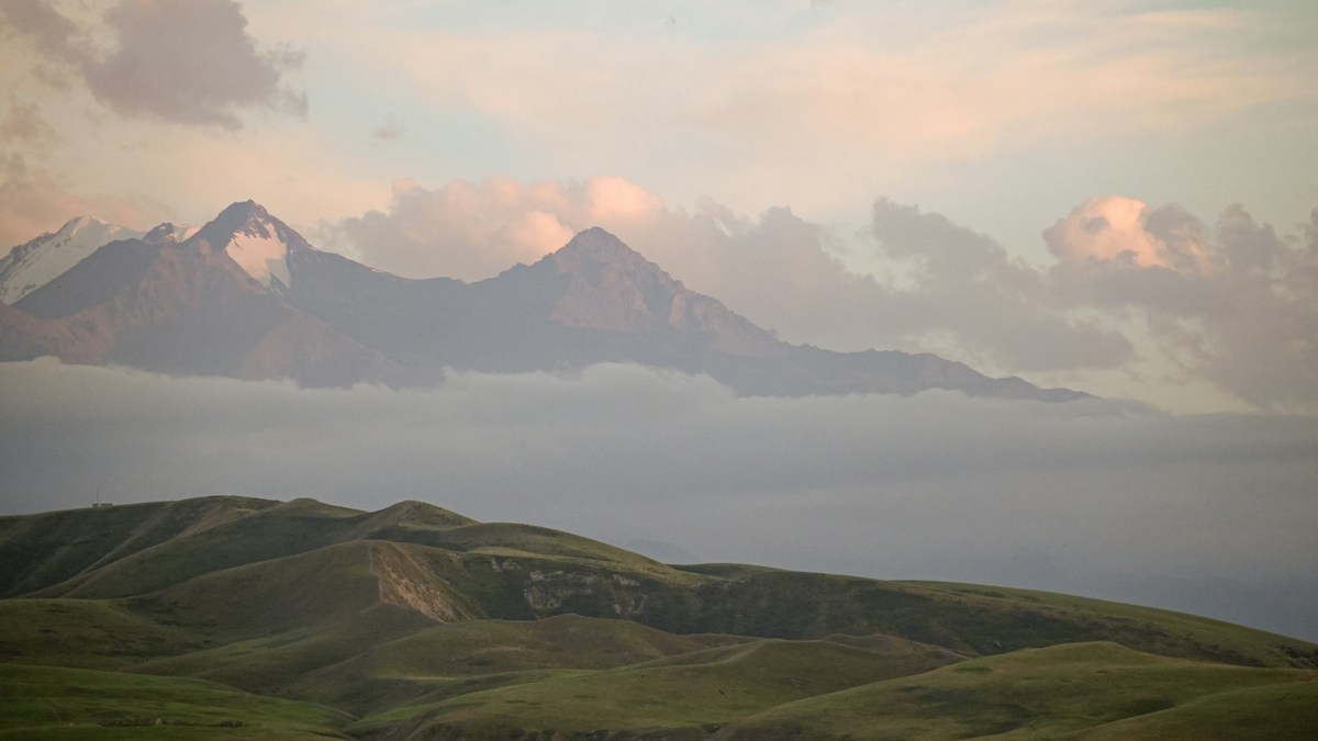 Misty mountains at sunrise with rolling hills
